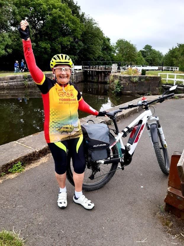 Cheering woman next to bike.