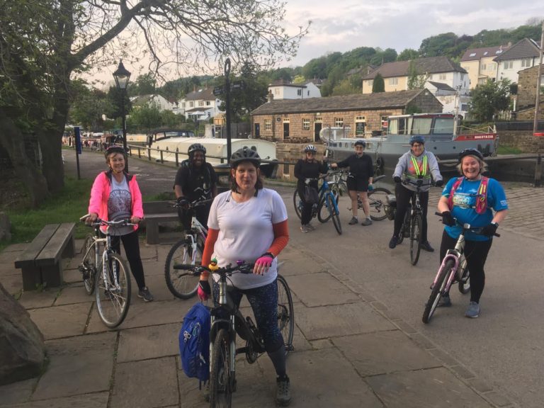 Women on bikes by the canal.