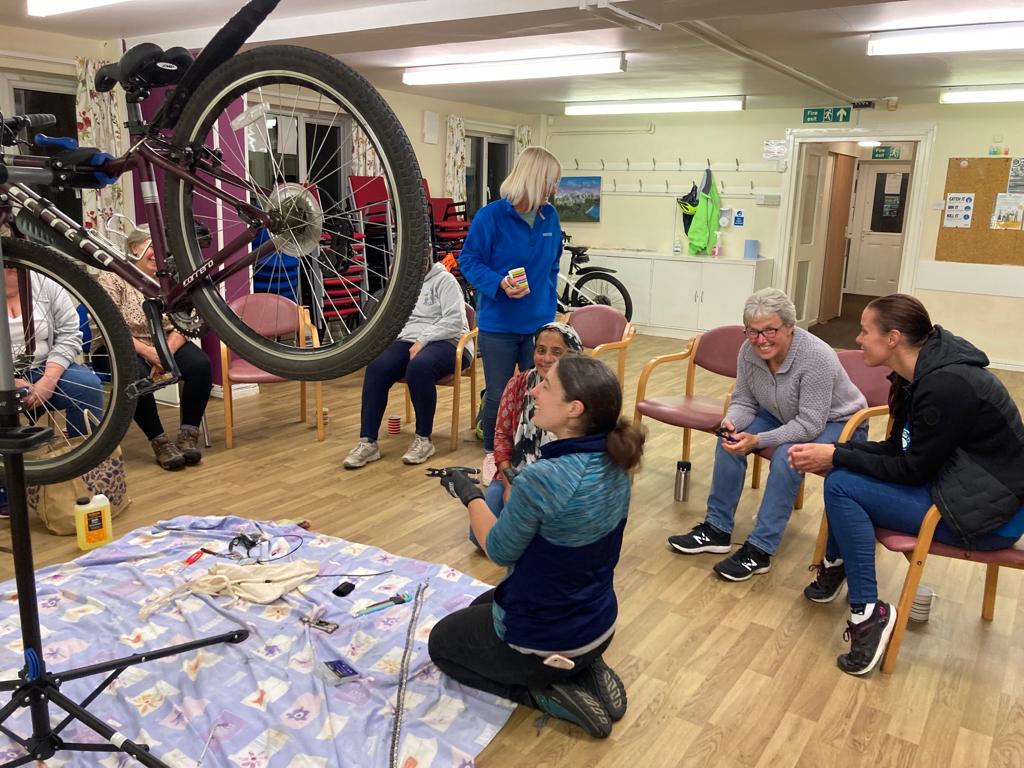 Woman leading bike workshop.