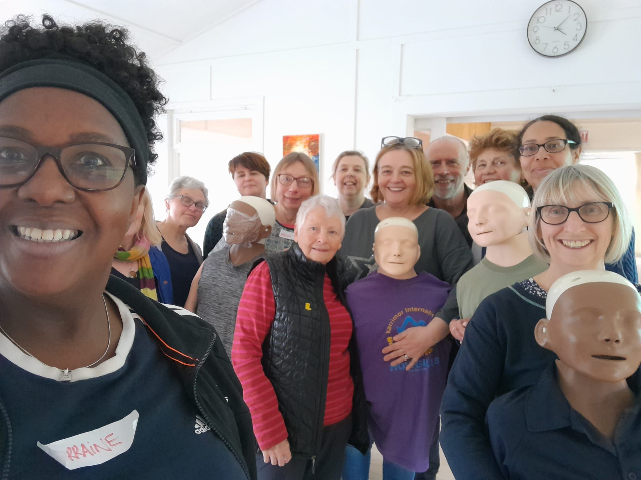 Group of student first aiders with instructor and manekins