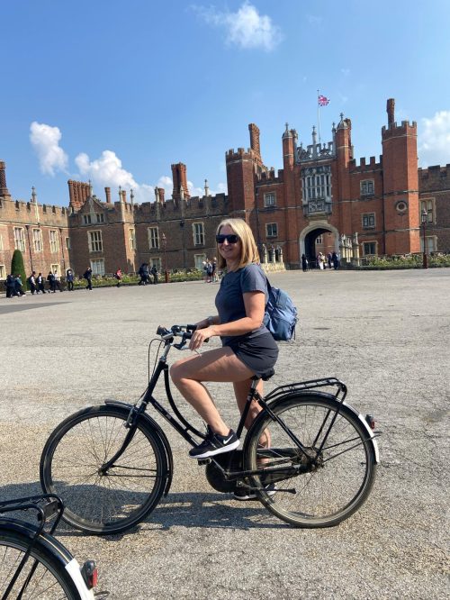 Woman cyclist in a castle forecourt