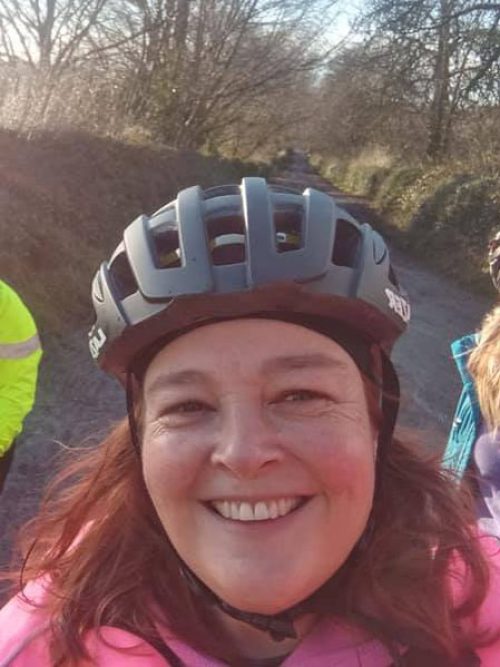 Selfie of smiling woman in bike helmet.