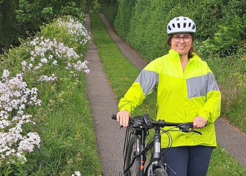 Lady Cyclist on path with bike