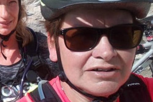 Selfie of woman in cycle helmet and sunglasses.