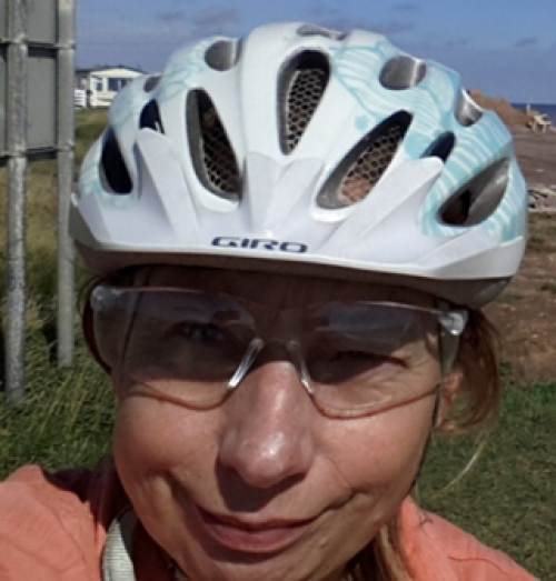 Woman in cycling helmet and glasses.