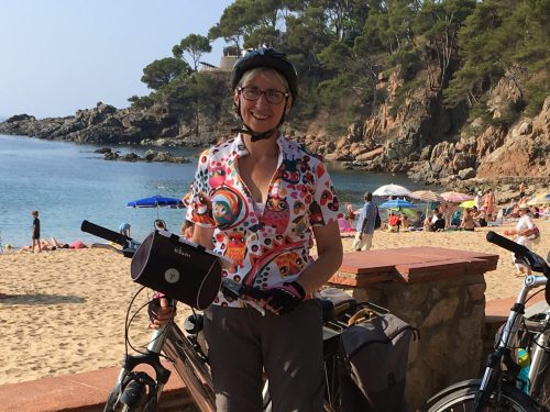 Woman with bike in front of sea