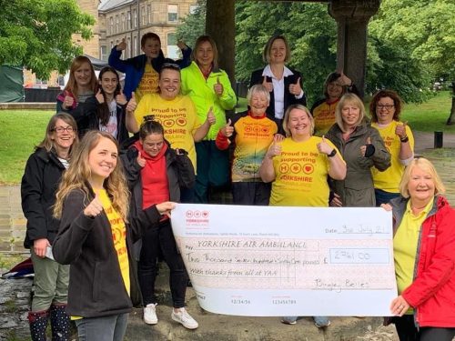 Group surrounding giant cheque.